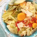 bowl of cabbage, carrots, and tomatoes