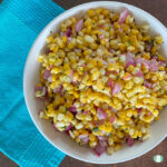 bowl of corn, purple onions, and seasonings