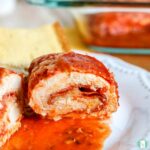 chicken stuffed with pepperoni and cheese and sliced in half on plate