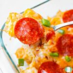 tater tots topped with pepperoni slices, diced green peppers, and melted cheese