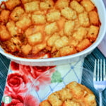 casserole dish and plate with tater tots on meat sauce