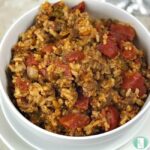 bowl of rice, ground beef, and tomato chunks