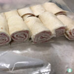 flour tortillas rolled with cream cheese and ham slices and cut in thirds