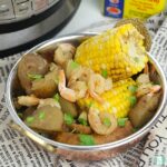 bowl of corn on the cob pieces, potatoes, and shrimp
