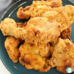 crispy breaded chicken drumsticks and pieces on a plate