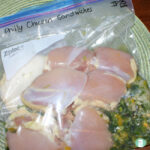 clear plastic bag with chicken and some green peppers and onions
