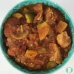 bowl with chunks of meat and vegetables in a red sauce