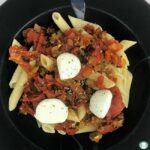 penne pasta with sausage, diced tomatoes, and balls of bocconcini cheese