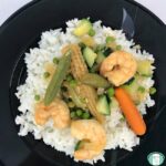 baby corn, shrimp, snow peas, baby carrots, and other vegetables on rice
