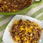 ground beef and corn in a skillet and on a plate topped with cheddar cheese