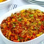 rice, ground beef, tomatoes, diced red and orange and yellow peppers in a casserole dish