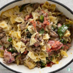 bow tie pasta with ground sausage, spinach, and tomatoes
