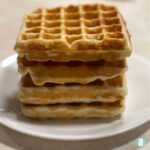 four waffles stacked on a plate
