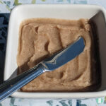 brown spread in a square bowl with a knife in it